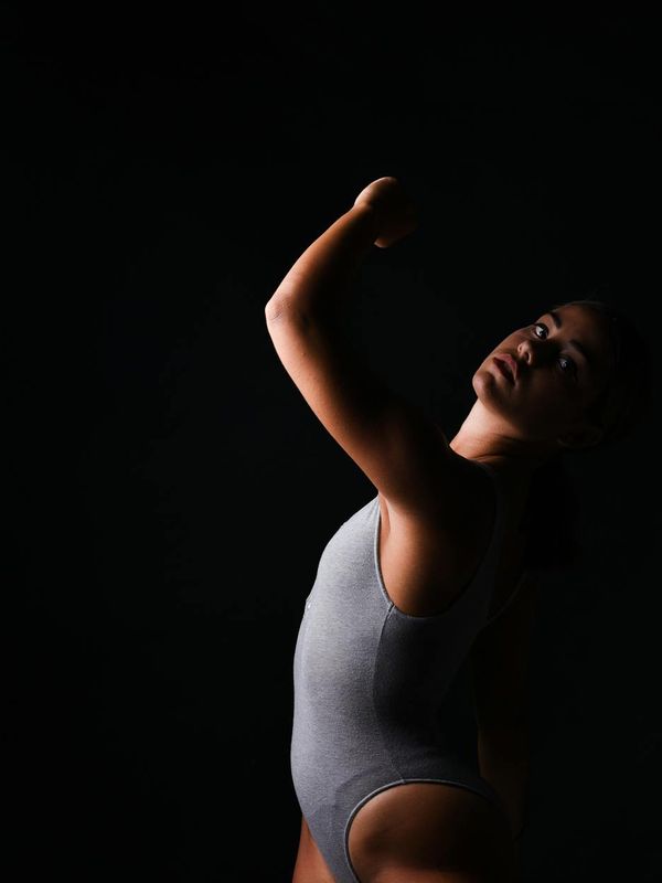 Silhouette of a person in a complex yoga pose showing strength and flexibility.